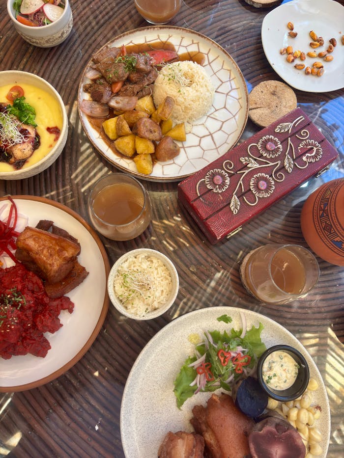 Authentic Peruvian cuisine featuring colorful dishes and beverages on a decorative table.